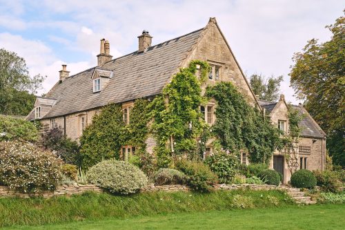 Quaint exterior of Withington Grange cottage in the Cotswolds